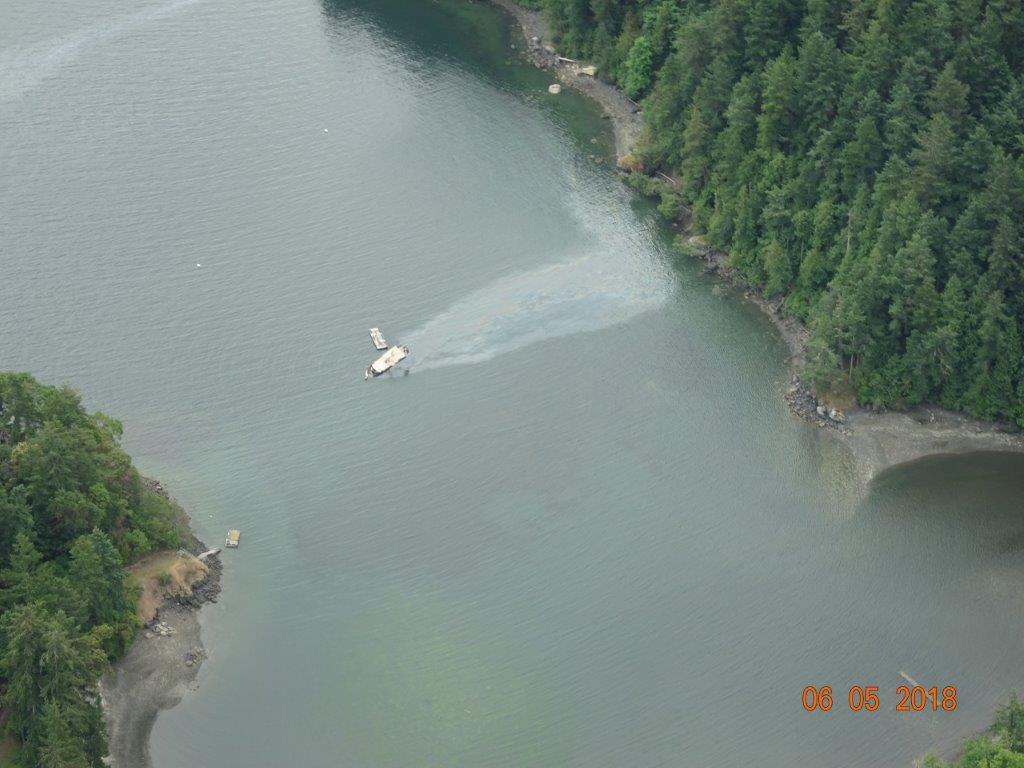An oil sheen coming from a vessel in a waterway.