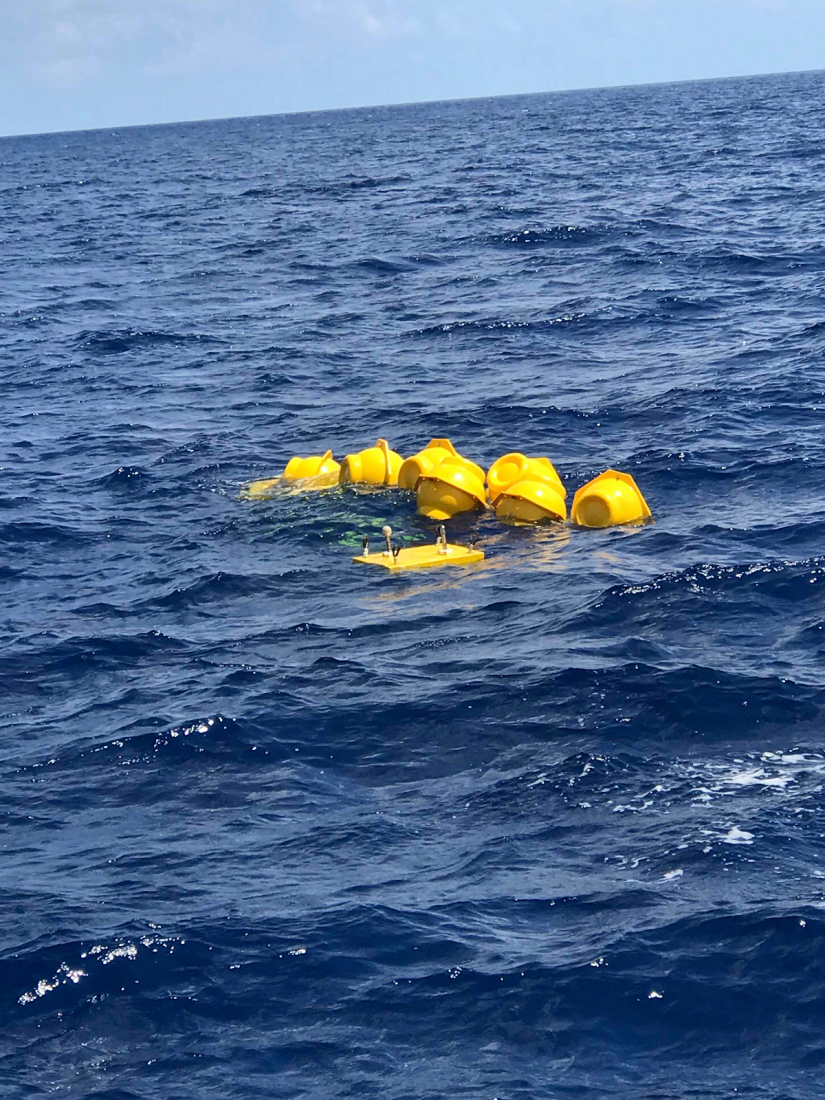 A yellow device floating in the water.