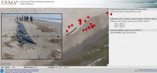 An ERMA screenshot with an image showing a black tarp on a beach to simulate oil. 