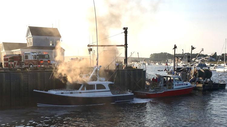 Smoke rising from a vessel at a dock.