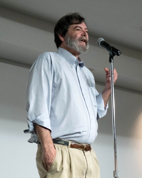 A man talking into a microphone.