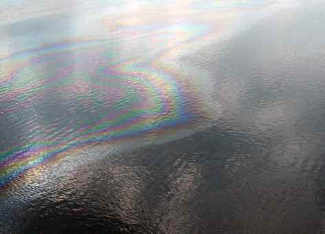 An aerial view of an oil sheen in a body of water.