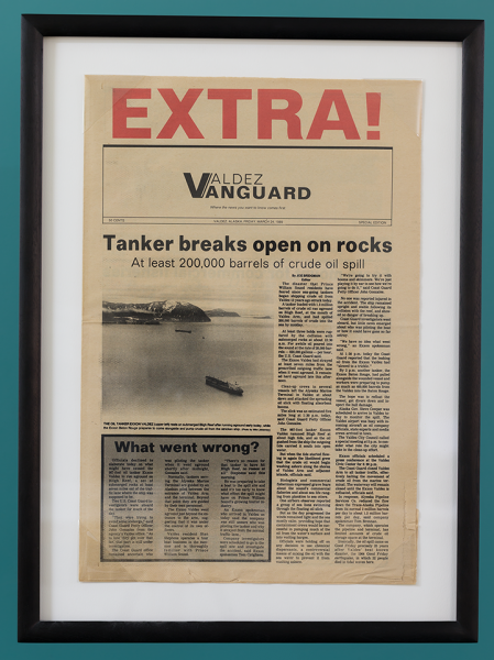 A newspaper clipping with the headline "Tanker breaks open on rocks."