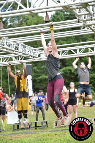 A woman competing in an obstacle course. 