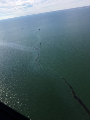 An oil sheen and dark visible oil from an aerial view. 