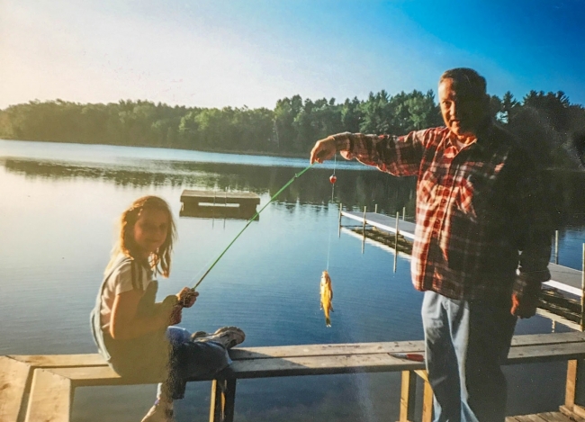 A man and a little girl fishing.