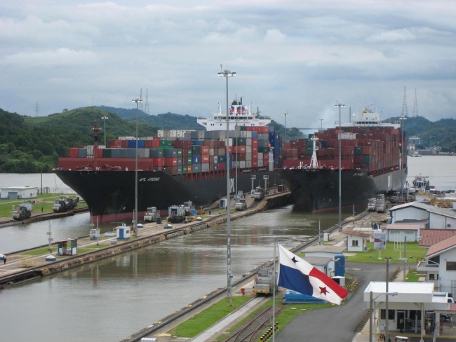 Two container ships passing through canal locks.