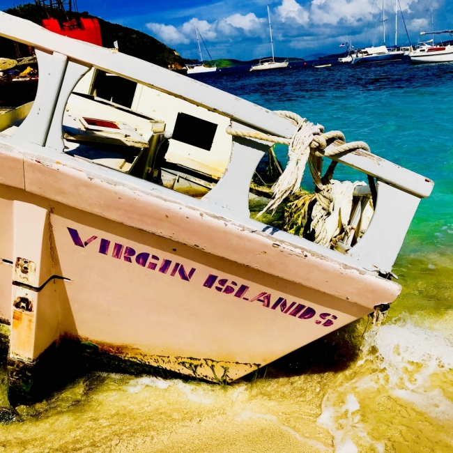 A boat on a beach with the text "Virgin Island" on it. 