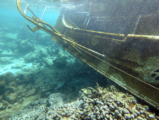 An underwater photo of a derelict vessel. 