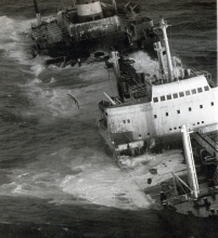 An old black and white photo of a grounded vessel. 