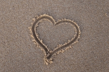 A heart drawn in sand. 