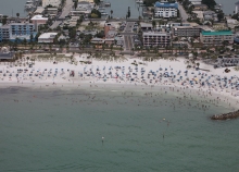 An aerial view of a beach with people on it. 