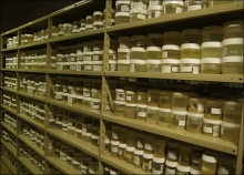 Specimen containers lining multiple shelves. 