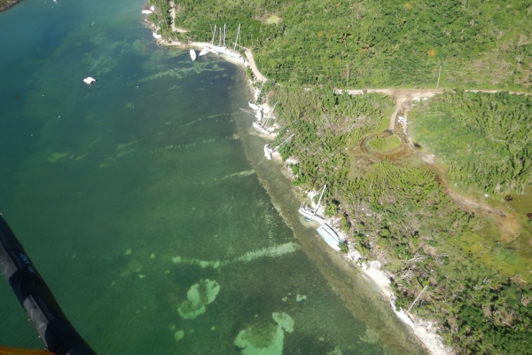 An aerial view of grounded vessels along a shoreline. 