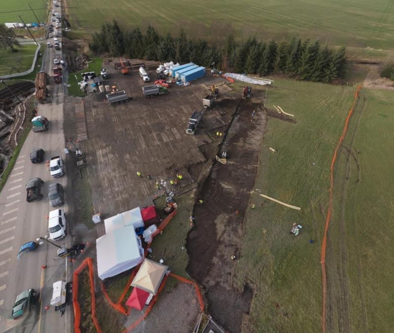 BP contractors excavating gasoline-contaminated soil at an agricultural field adjacent to Olympic Pipeline vault where the discharge of gasoline occurred. Heavy equipment staging area on rig-mat placed on agricultural fields alongside SR 534.