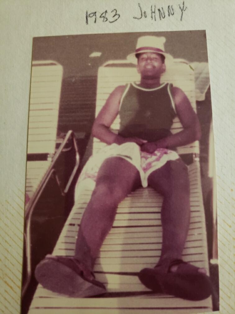 An old photo of a person on a beach chair.