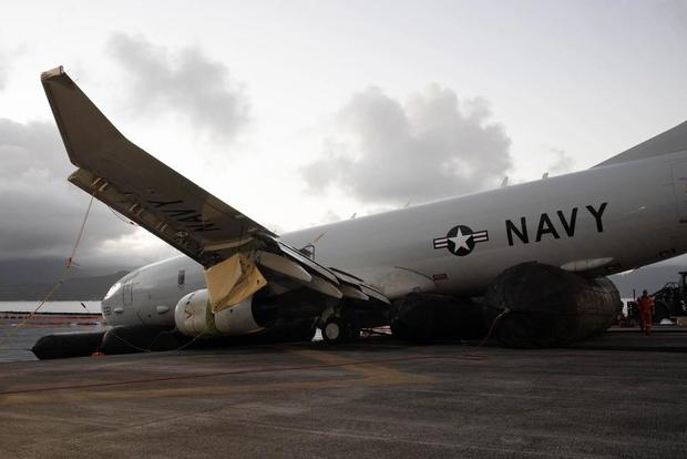Salvaged aircraft lies on runway with inflatable roller bags observed on the aircraft's wings