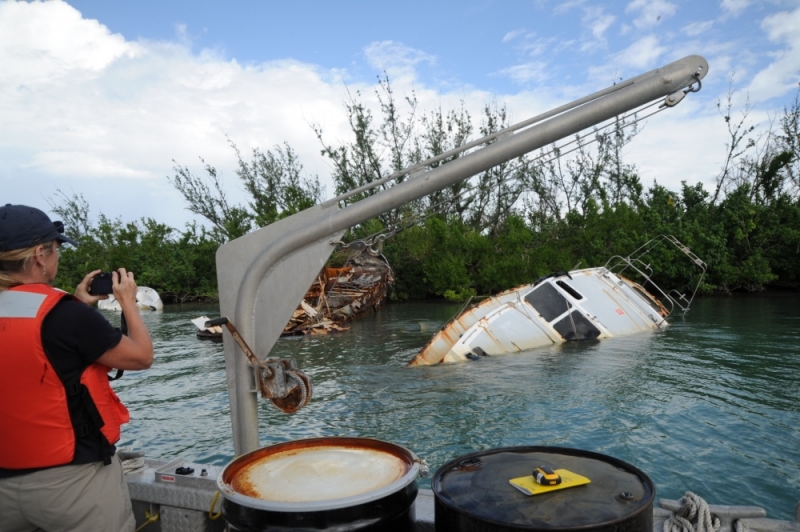 A person taking a photo of a displaced vessel. 