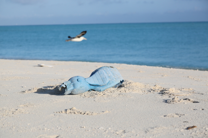 A beach toy left on a beach. 