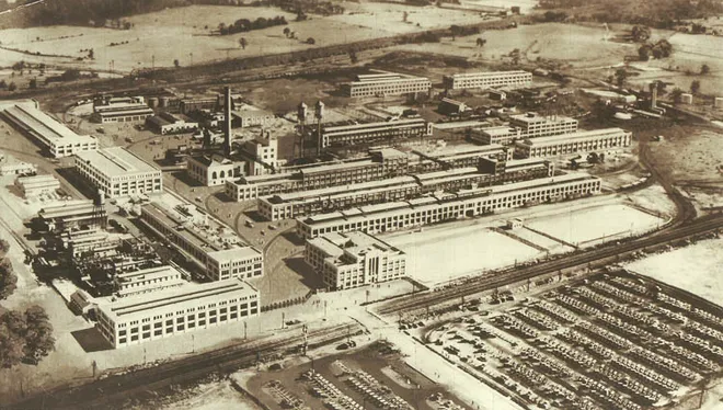 An 1960 sepia-toned aerial image of a manufacturing facility.