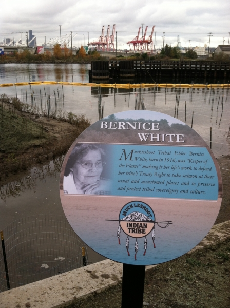 A sign with the name "Bernice White" and a picture of a woman in front of a shoreline. 