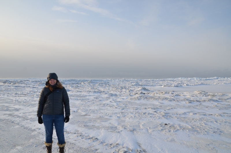 A woman standing on a snowy landscape. 