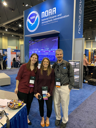 Three people in front of a NOAA logo. 