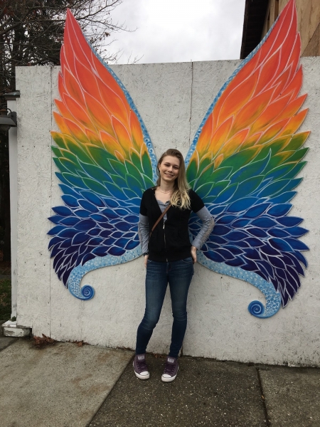 A girl posing with butterfly wings. 