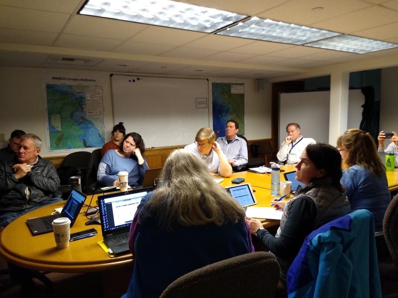 A group of people around a conference table.