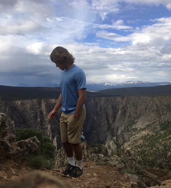 A person with a rocky canyon in the background.