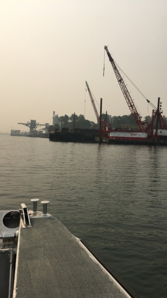 An industrial shoreline as seen from a boat.