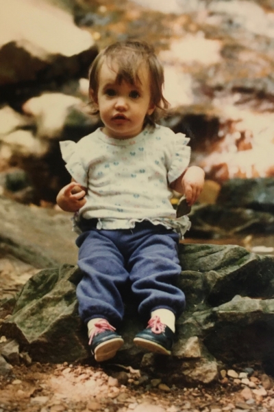 A child sitting on rocks.