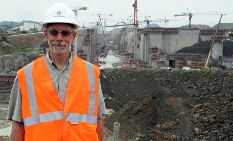 A man in an orange vest and hard hat.