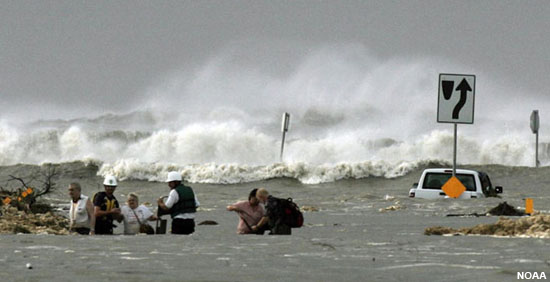 People standing in storm surge waters.