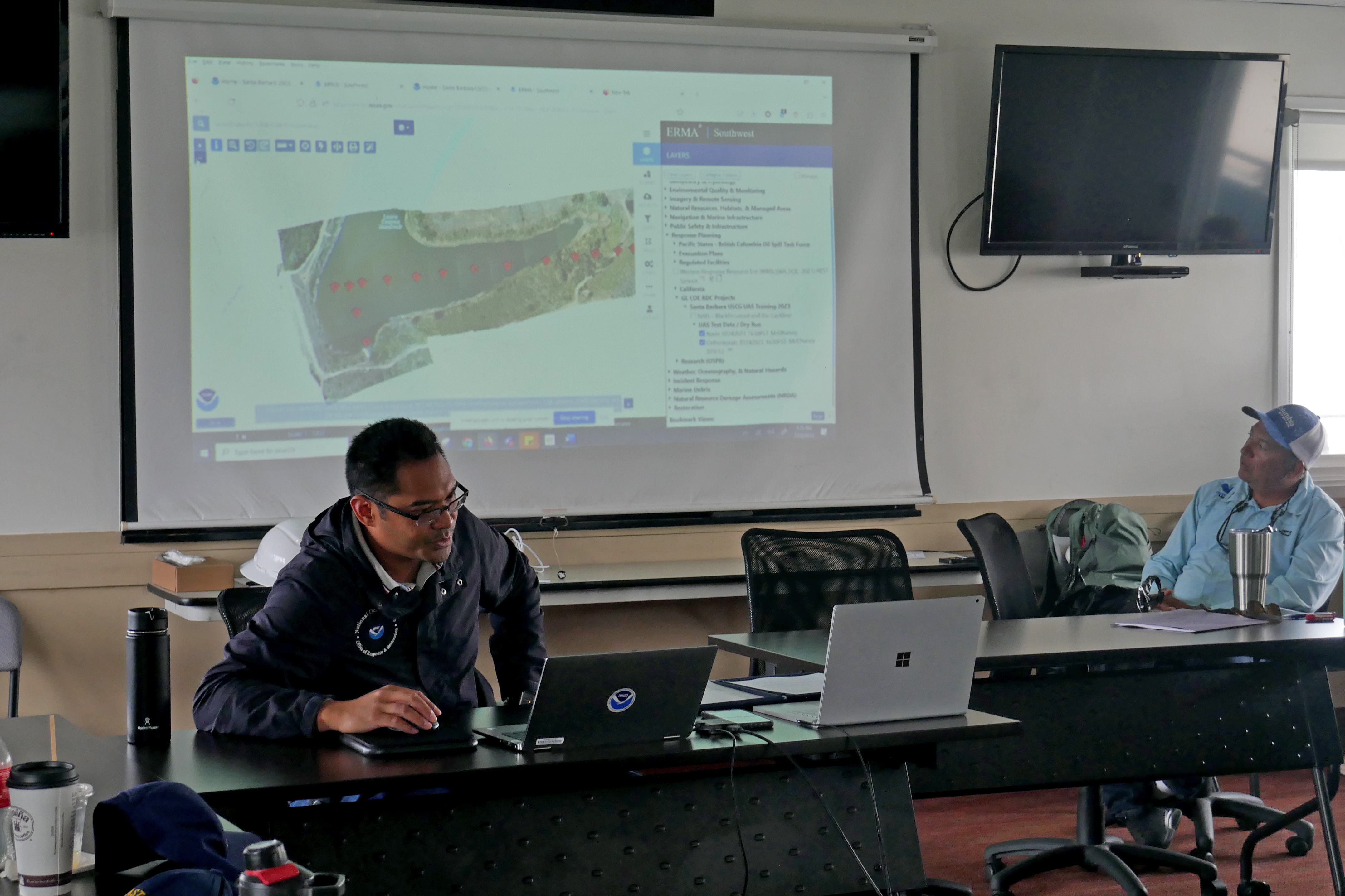 Spatial data specialist instructs class of drone pilots on the use of OR&R's Environmental Response Management Application (ERMA).
