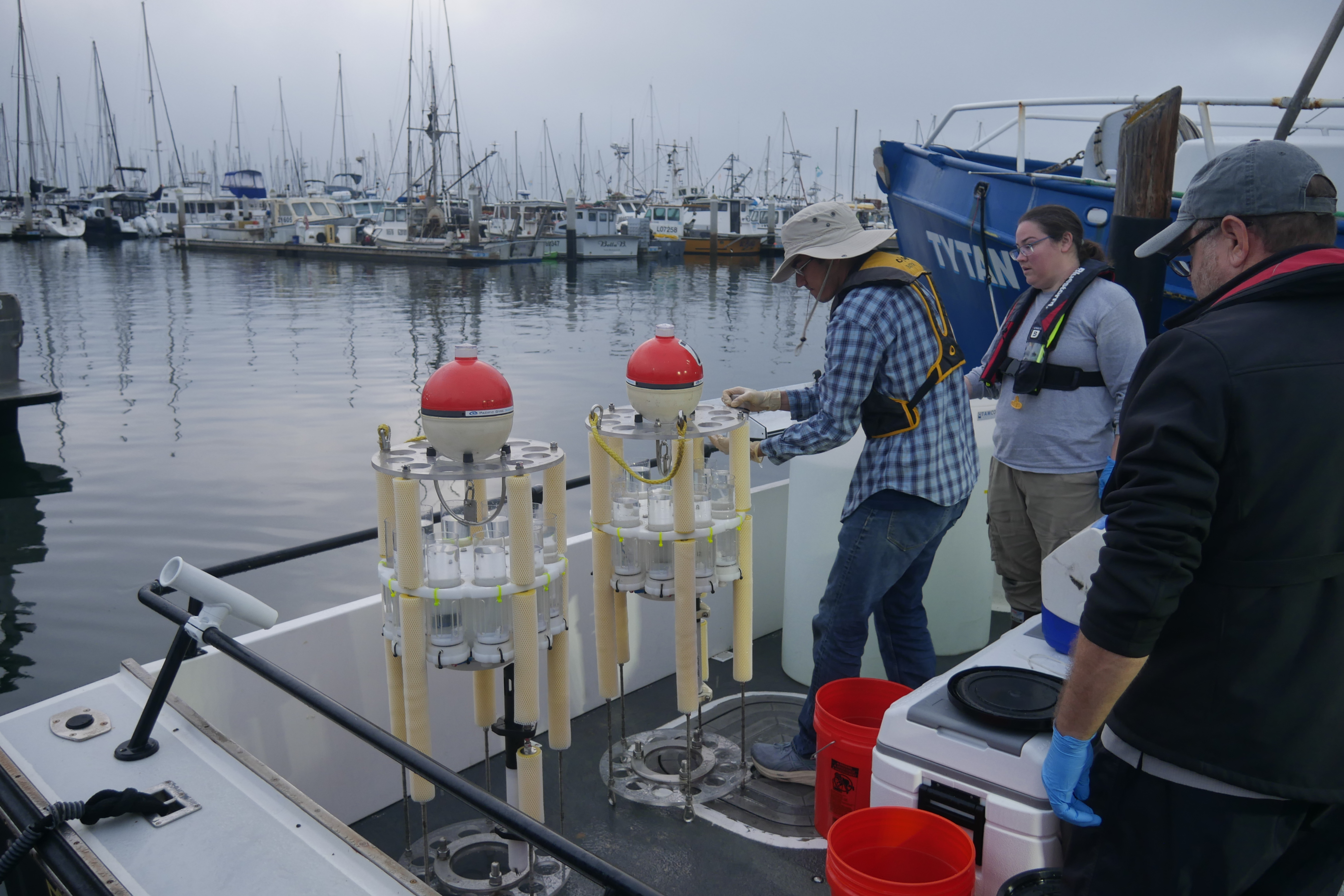 Scientists aboard a vessel preparing to deploy remotely operated vehicles.