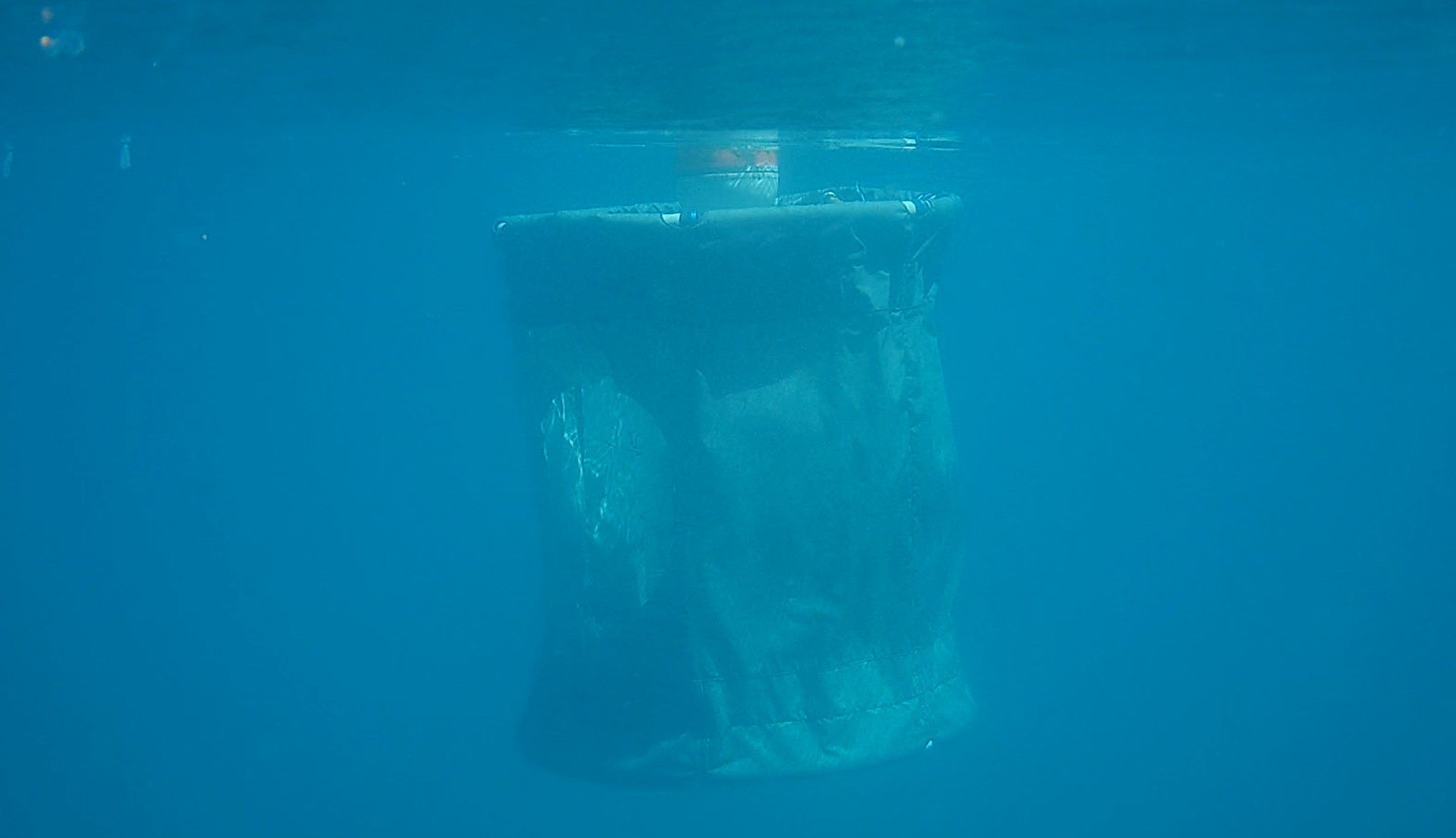 An underwater photo of a DEEAR unit deployed in the water column.