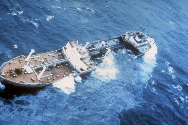 Oil spilling from a partially submerged vessel. 