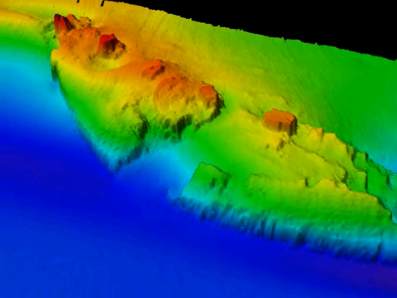 A digital map in blue, green, and red depicting underwater terrain.