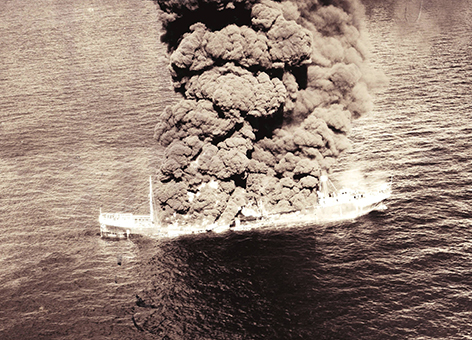 An old black-and-white photo of an explosion on a vessel.