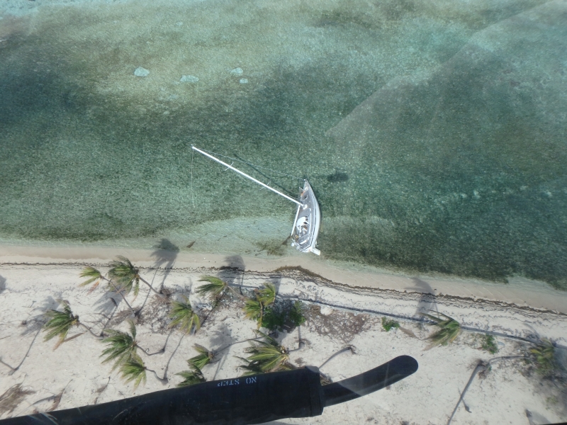 A vessel grounded in a reef in water. 