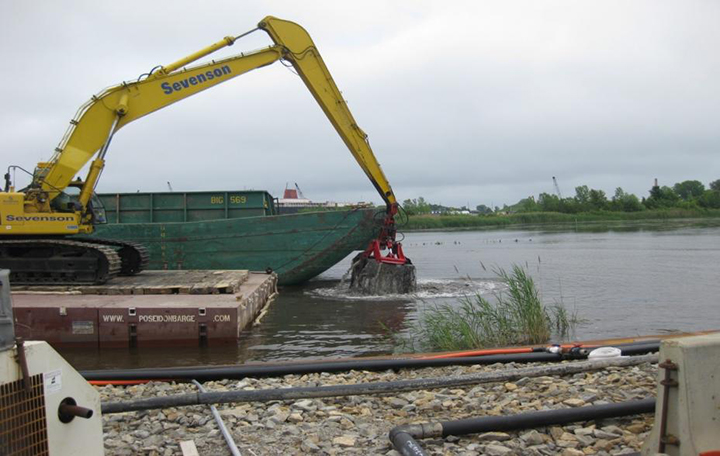 An excavator dredging sediment. 