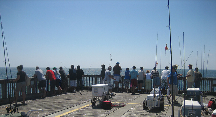 People on a dock fishing.