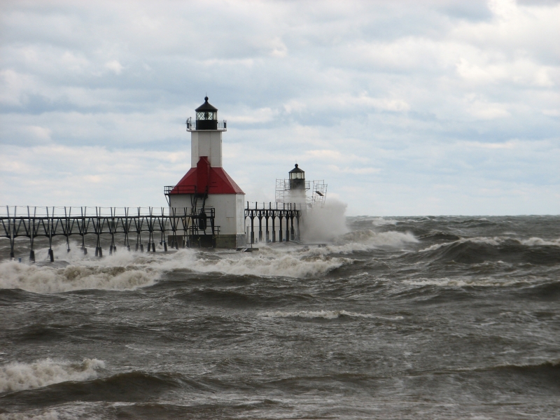 Waves crashing into a lighthouse. 