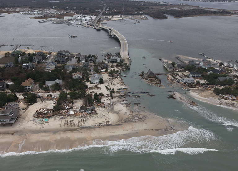 An aerial view of damaged houses and highways. 