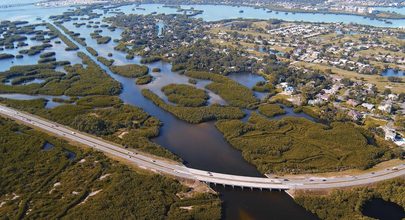 An aerial view of a marsh surrounded by coastal development. 