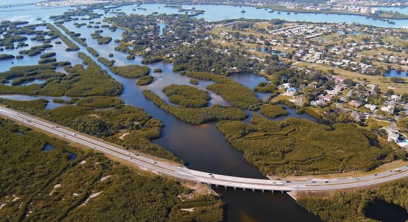 An aerial view of a marsh in an urban area.