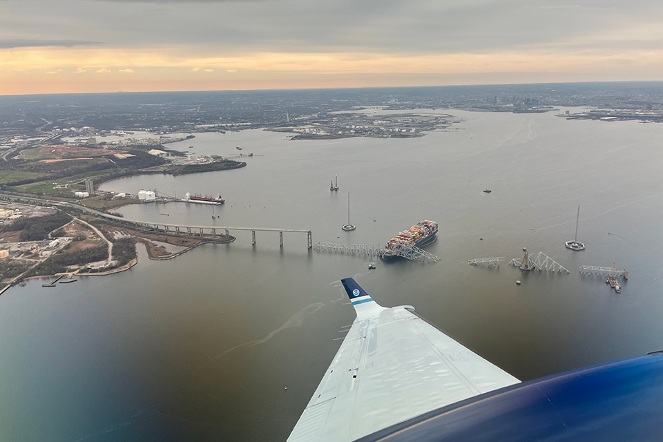 March 28, 2024: View from NOAA King Air N68RF aircraft during a navigation survey following the collapse of the Francis Scott Key Bridge in Baltimore. The bridge and the MV Dali, the container ship involved in the incident, are visible.