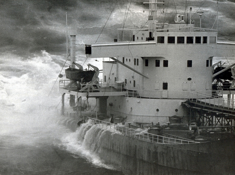 An old black and white photo of water covering the deck of a vessel. 