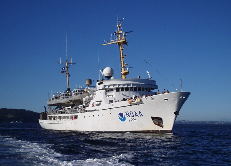 A ship with a NOAA logo on it in the water. 